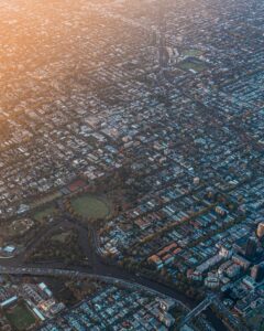 A stunning aerial view of Melbourne, Australia, showcasing the Yarra River and cityscape at sunrise.